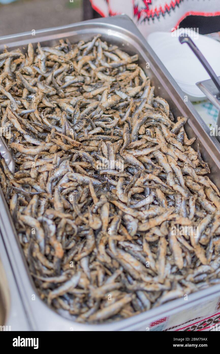 Fried little fish in market or food festival, food truck, asian market