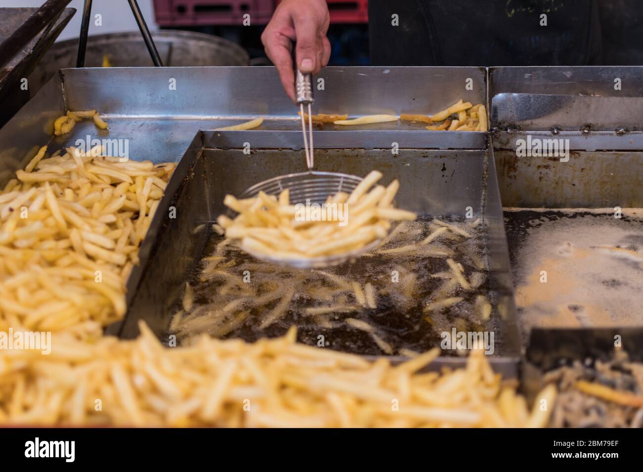 Deep fried fast food potatoes fries, during fast food festival Stock