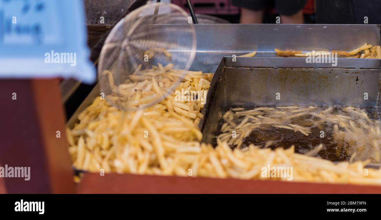 Deep fried fast food potatoes fries, during fast food festival Stock