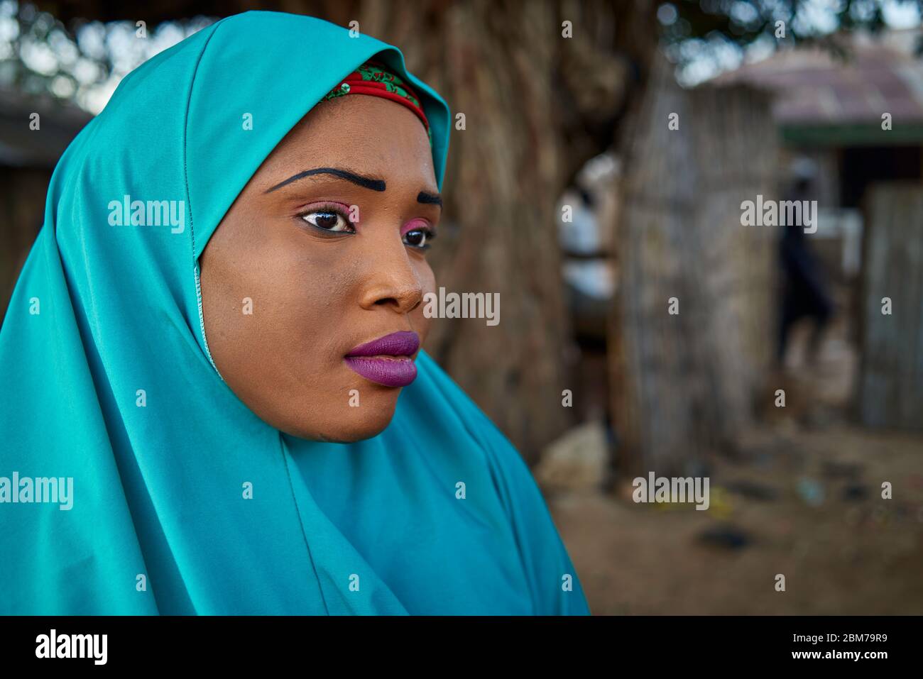 Portrait of a young Muslim woman with makeup, her head covered by a hijab. Stock Photo