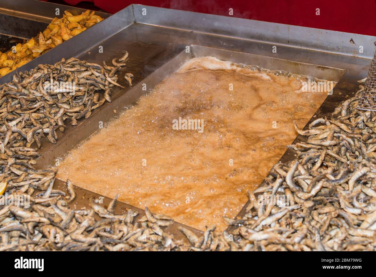 Fried little fish in market or food festival, food truck, asian market