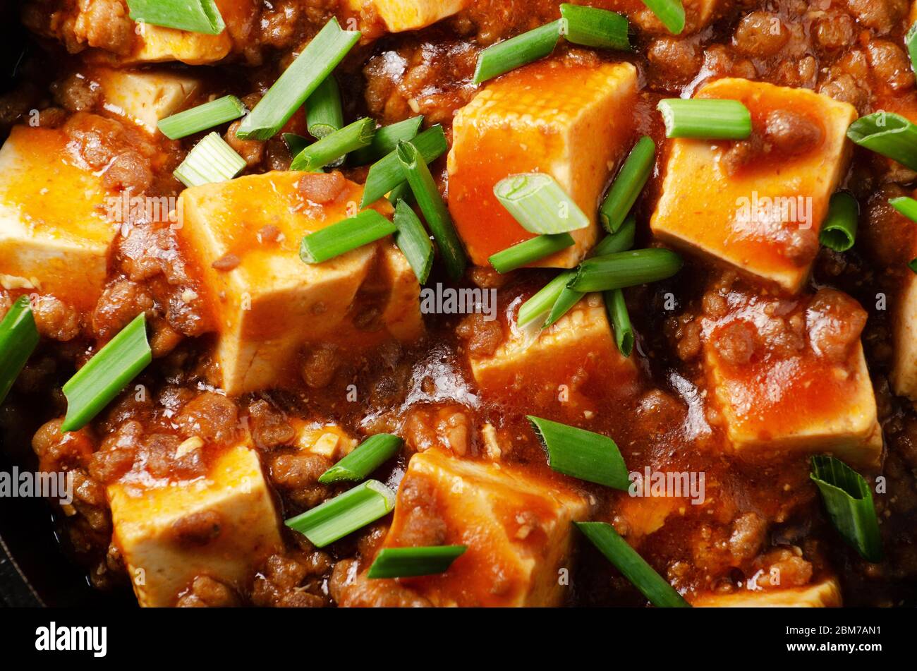 Mapo tofu in cast iron skillet with pork chopped chives soy sauce