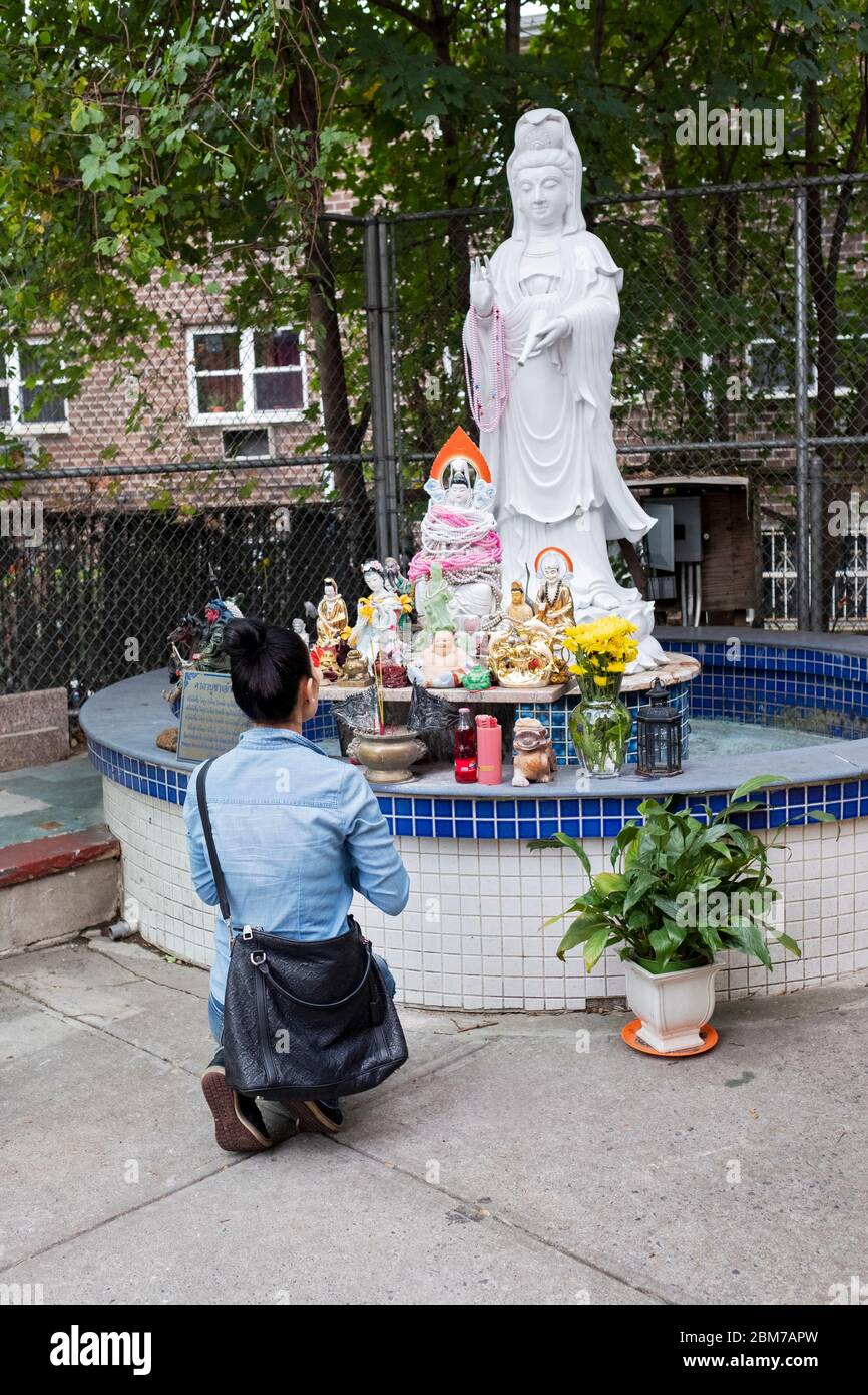 A devout Buddhist from Thailand kneels, worships and prays in front of