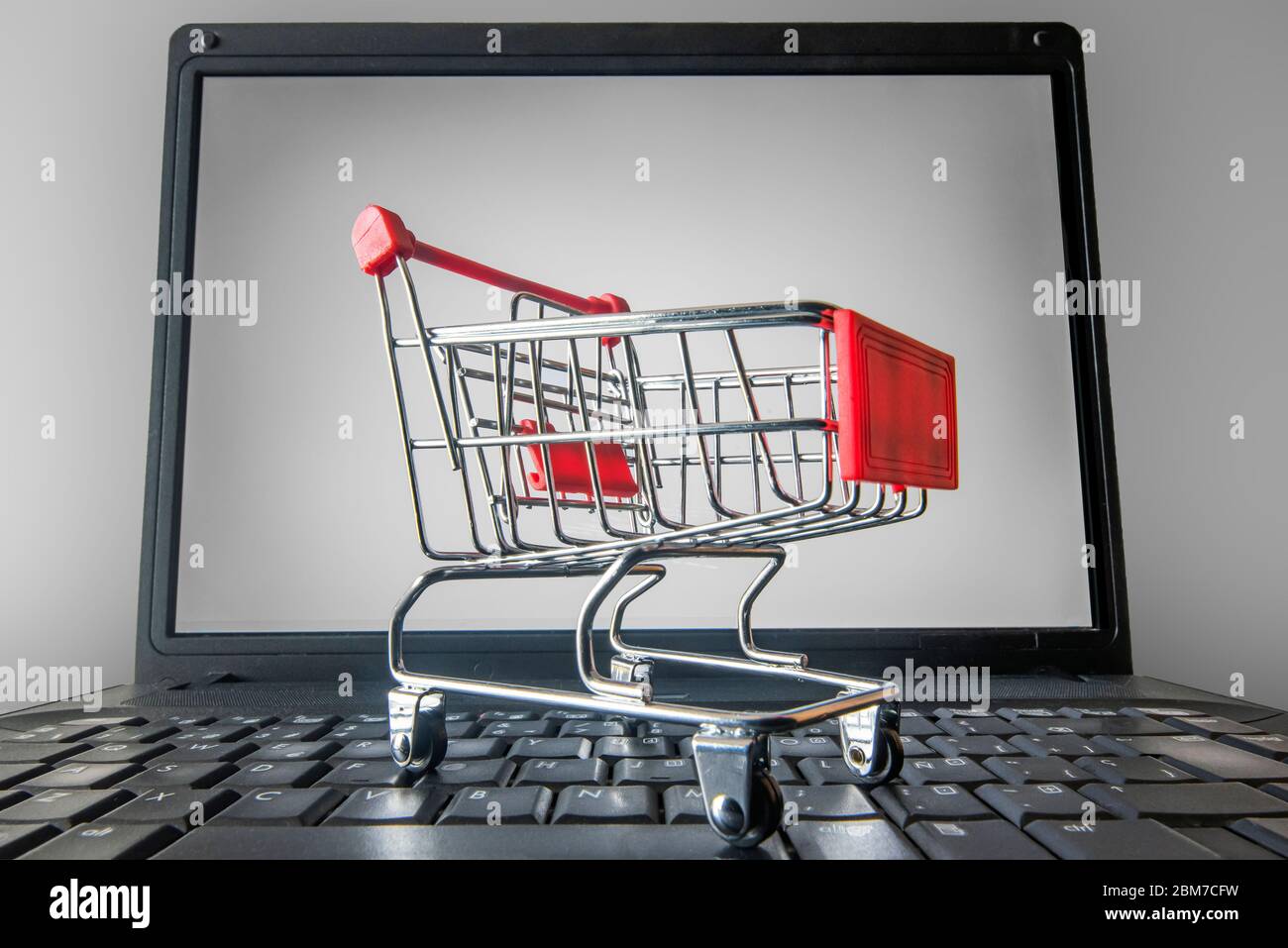 shopping cart on top of a laptop keyboard. Stock Photo