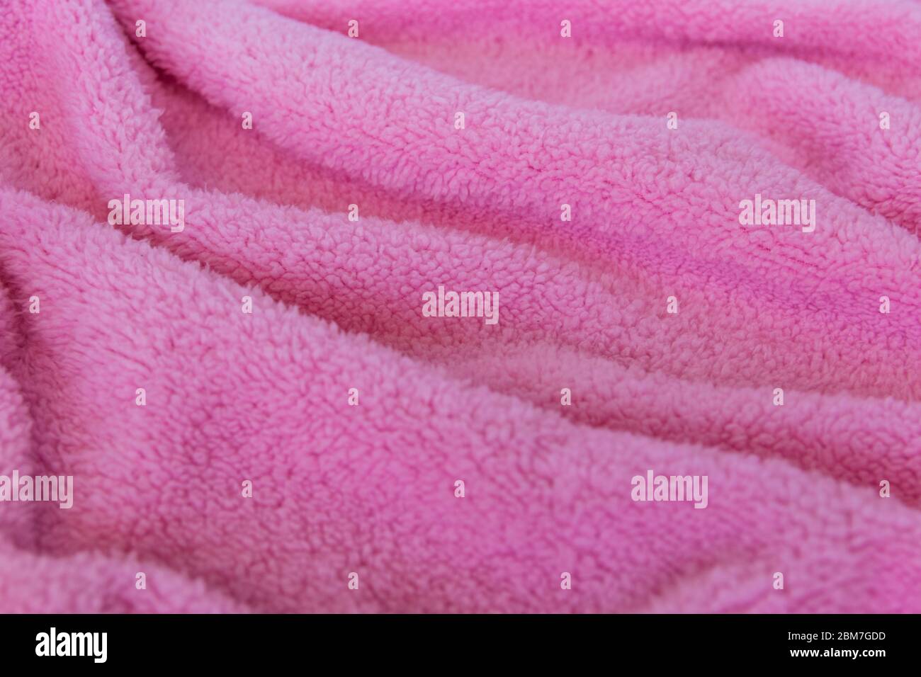 Bright texture fabric. Textile pink knitted cloth background. Stock Photo