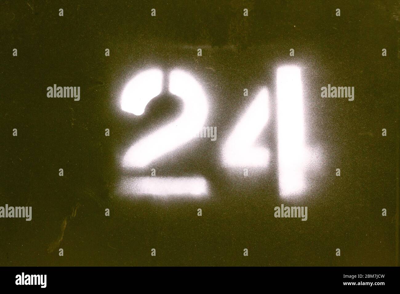 24 sprayed onto a dark green background in military style just like the army Stock Photo
