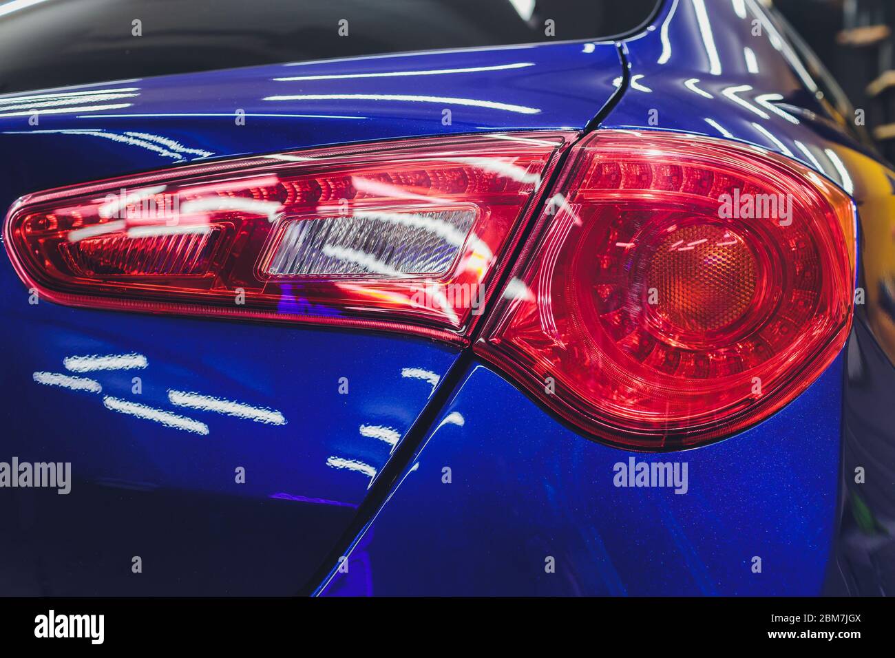 Red taillight of a modern car closeup. Service, repair, body repair