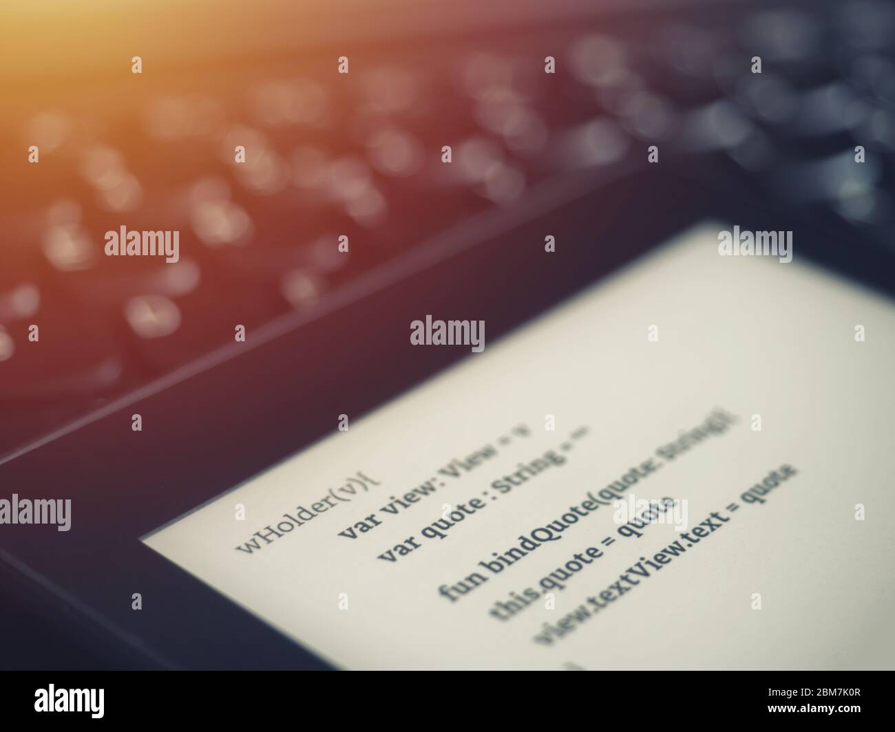 High view of a ebook reader with programing lessons on a laptop