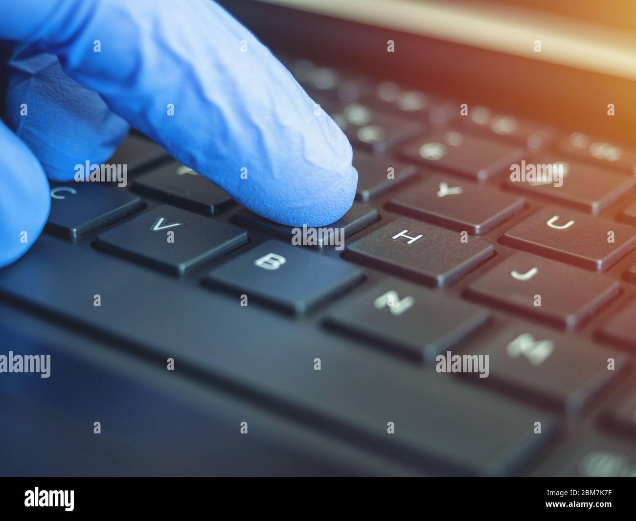 Online quarantine training. Remote online work. Coronovirus. Epidemic. Hands in protective medical gloves are typing on the keyboard. Stock Photo