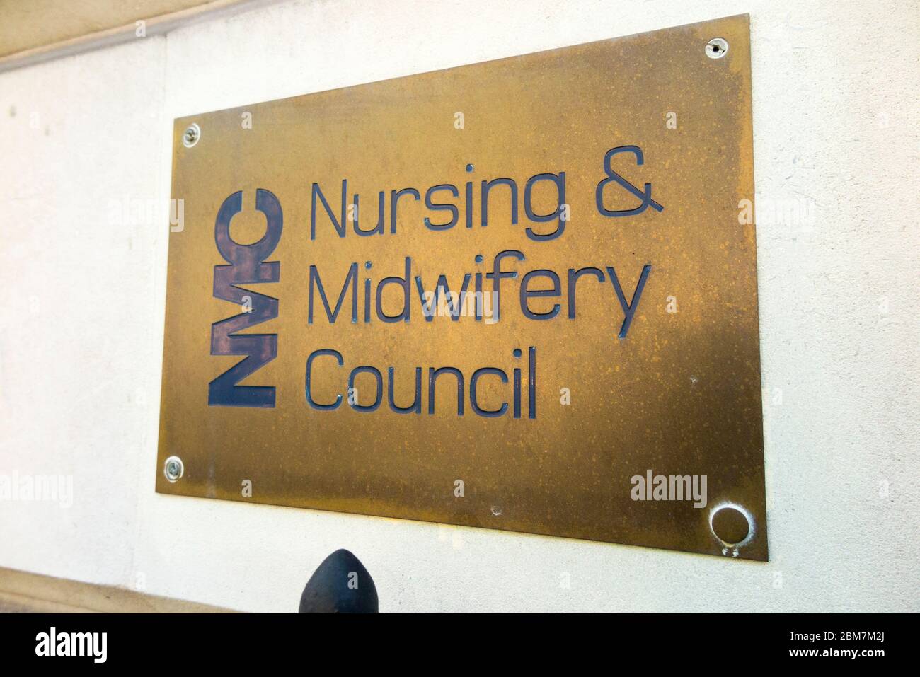 Brass name plate / plaque outside the offices of The Nursing and Midwifery Council – NMC at 23 Portland Place London W1B 1PZ. UK. (118) Stock Photo