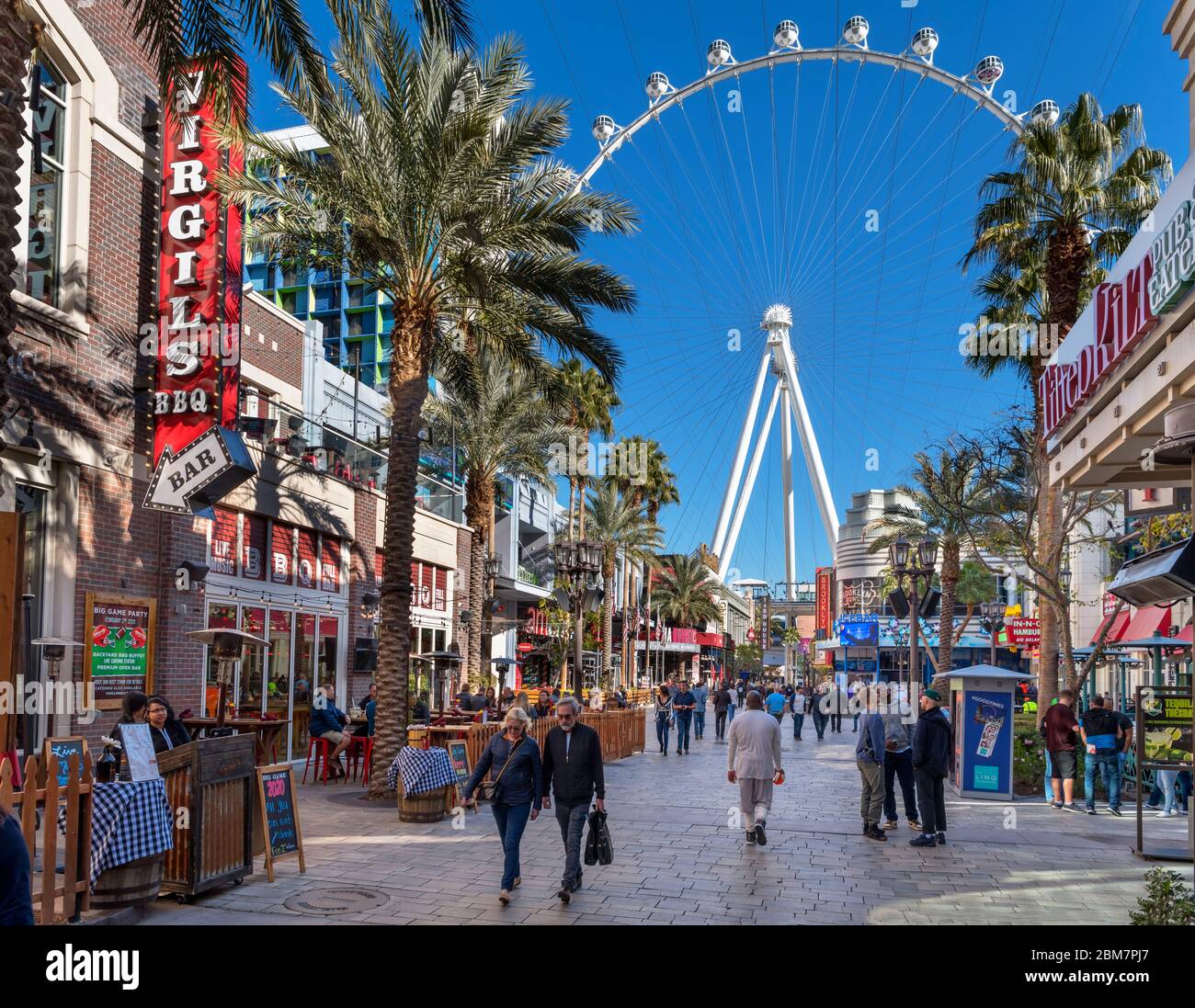 Shops, bars and restaurants on The Linq Promenade looking towards the High Roller ferris wheel,  Las Vegas Strip, Las Vegas, Nevada, USA Stock Photo