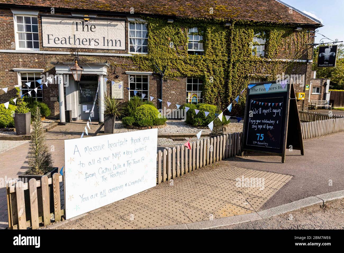 East Hertfordshire, United Kingdom. 07 May, 2020 Pictured: Despite being unable to open due to the COVID-19 restrictions, The Feathers pub in Wadesmill, Hertfordshire has put up bunting and messages to celebrate the VE Day 75th anniversary. Credit: Rich Dyson/Alamy Live News Stock Photo