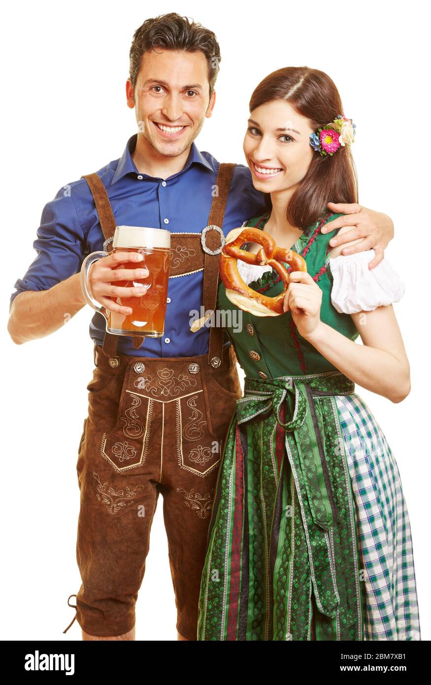 A laughing couple is wearing dirndls and lederhosen for the Oktoberfest in  Bavaria Stock Photo - Alamy