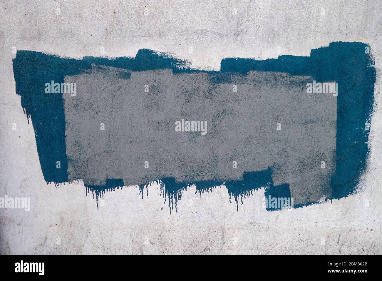 textured painted area on white wall with driipping bottom background; backdrop Stock Photo