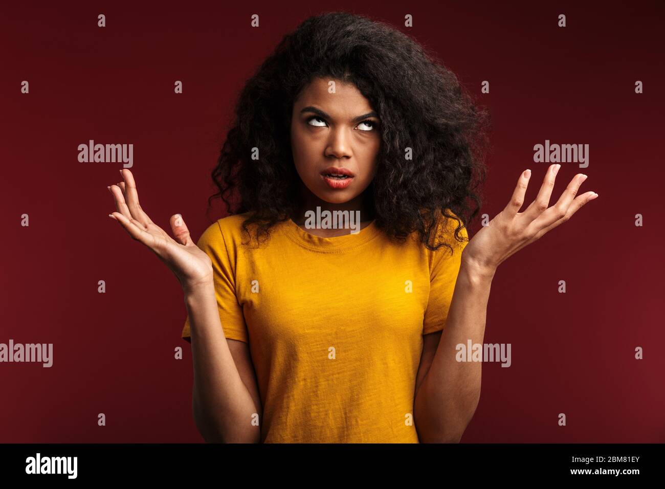 Image of disappointed brunette african american woman with curly hair ...