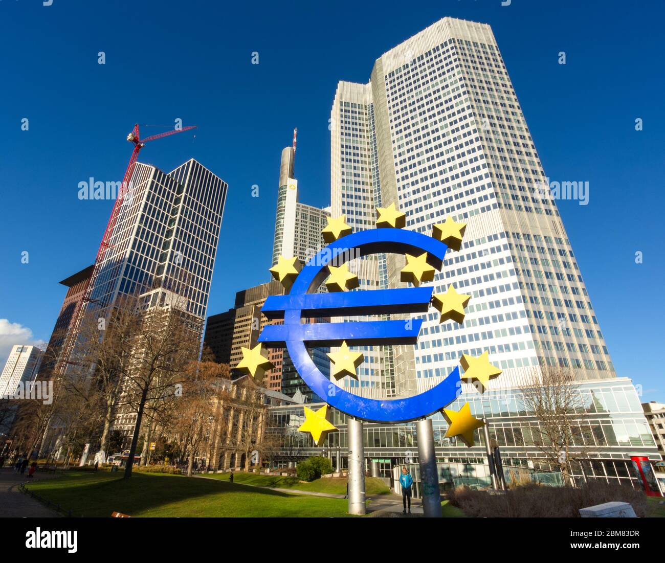 The Eurotower in Willy-Brandt-Platz, Frankfurt am Main, Hesse, Germany, with Euro currency symbol in the foreground. Stock Photo