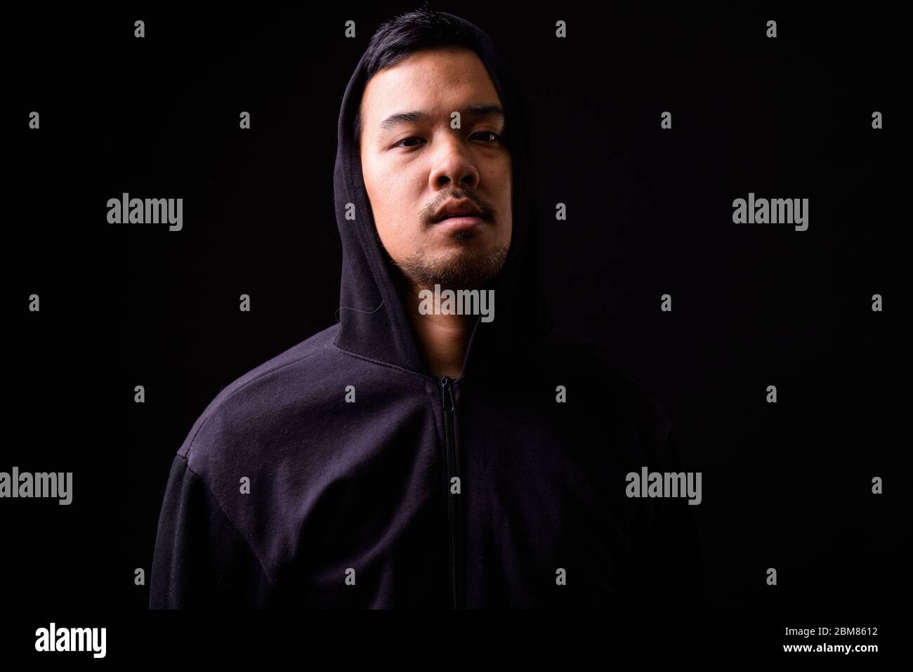 Portrait of young Asian man wearing hoodie Stock Photo - Alamy