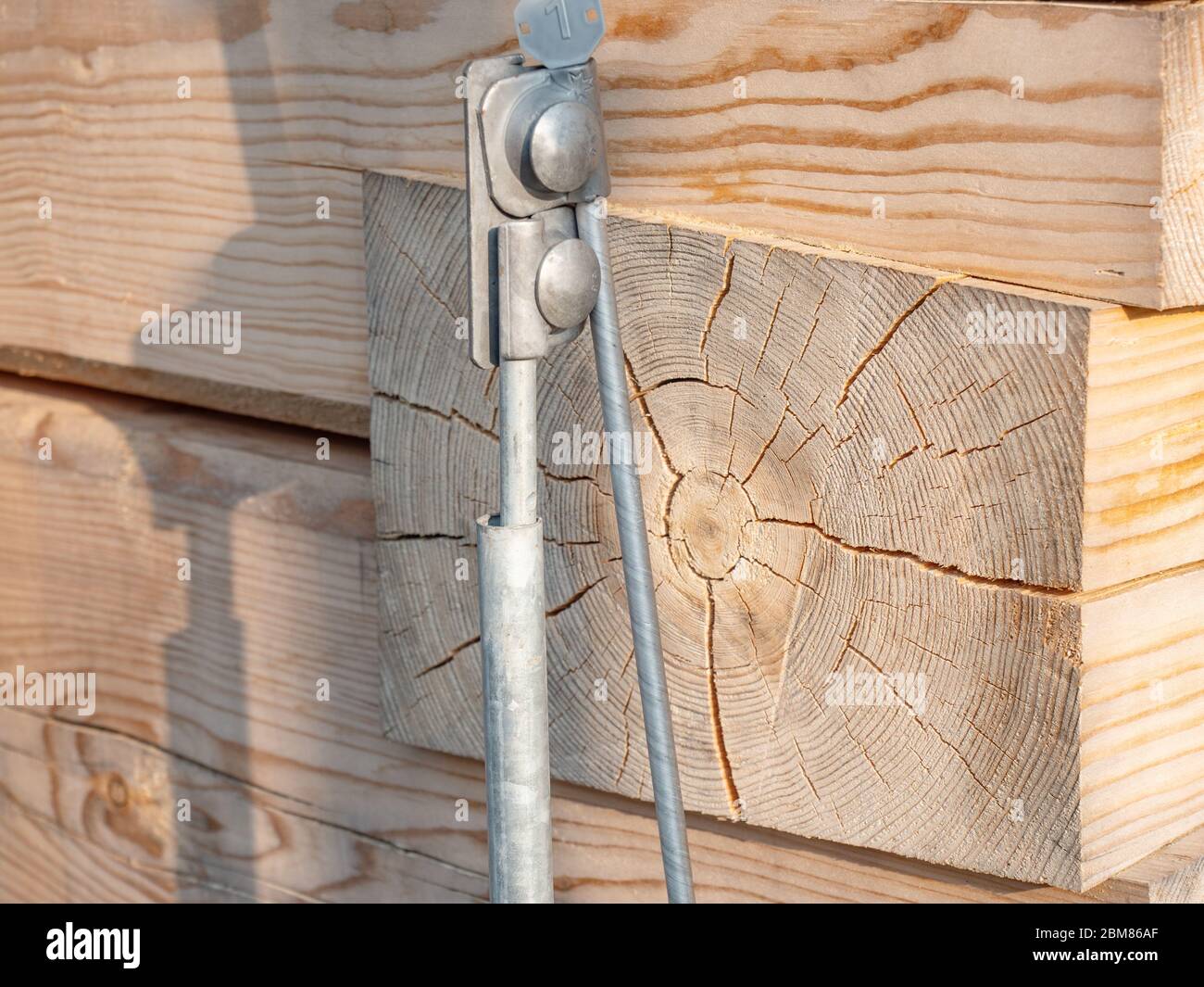 Detail of lightning conductor, wire lightning conductor on house wall from square beams from