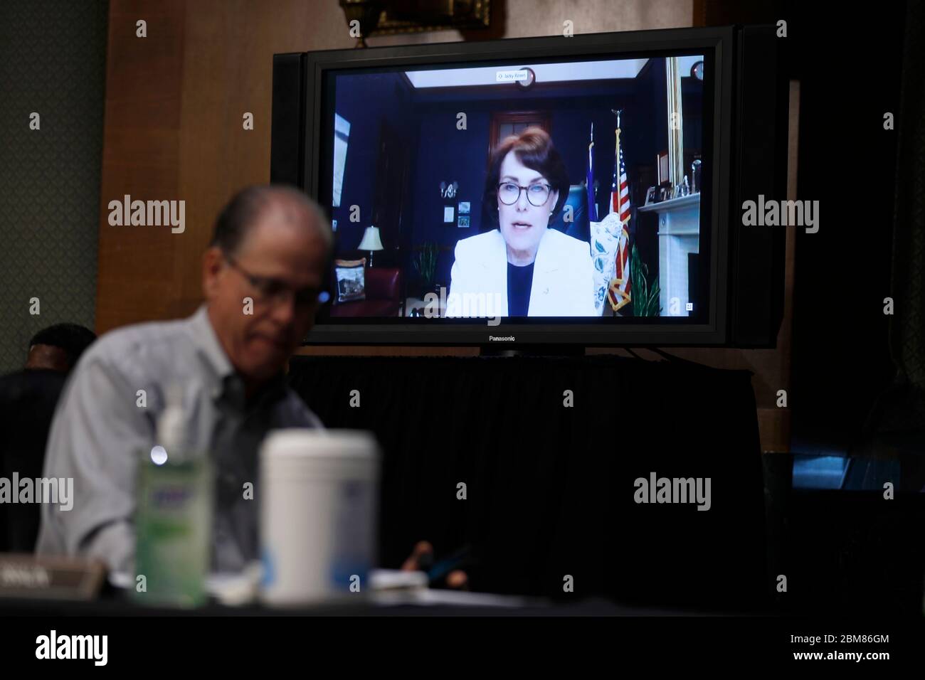 Washington, United States Of America. 07th May, 2020. United States Senator Jacky Rosen (Democrat of Nevada), speaks via teleconference behind US Senator Mike Braun (Republican of Indiana), during a Senate Health Education Labor and Pensions Committee hearing on new coronavirus tests on Capitol Hill in Washington, Thursday, May 7, 2020. Credit: Andrew Harnik/Pool via CNP | usage worldwide Credit: dpa/Alamy Live News Stock Photo