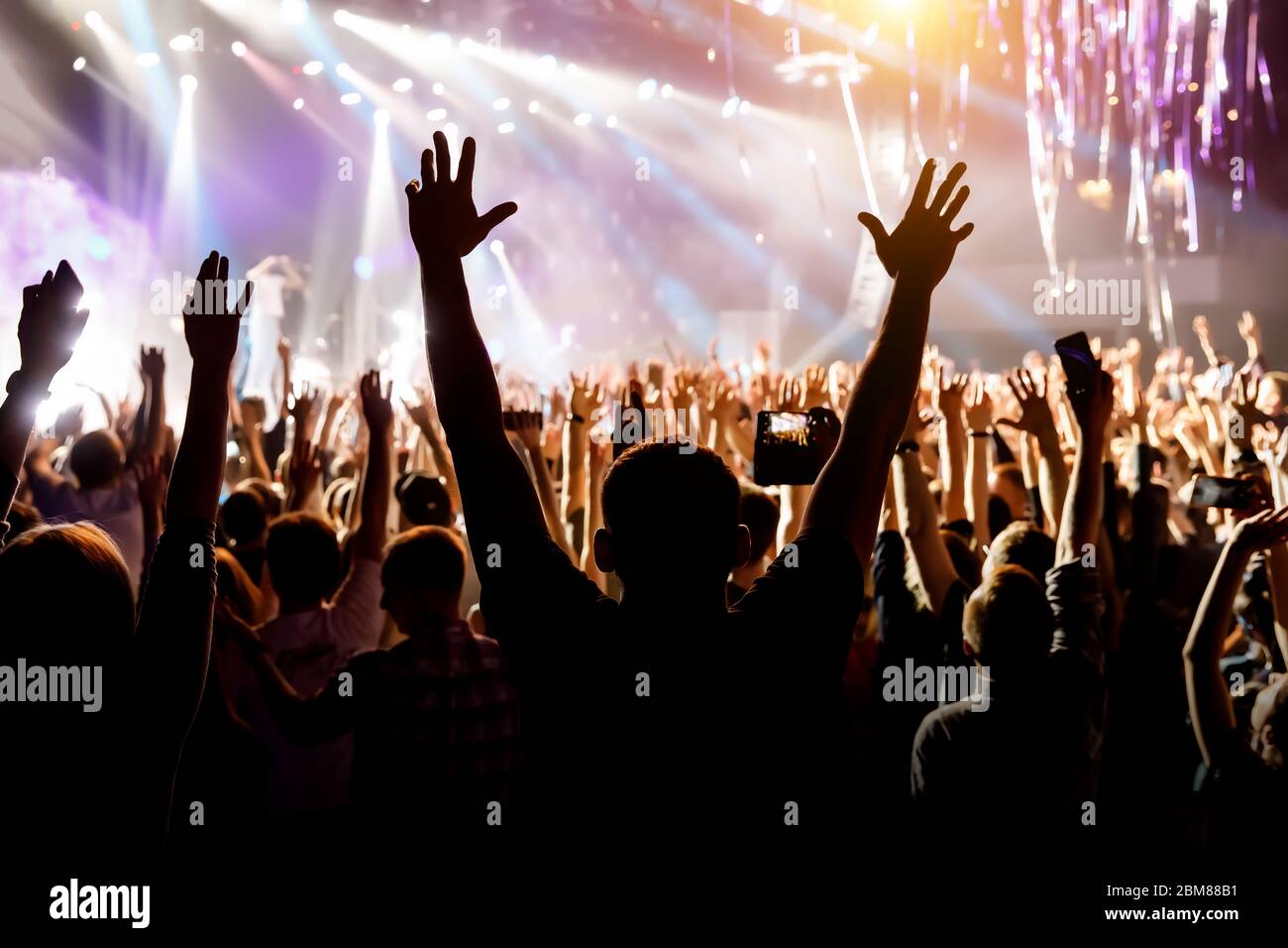 Crowd with raised hands on music concert Stock Photo - Alamy