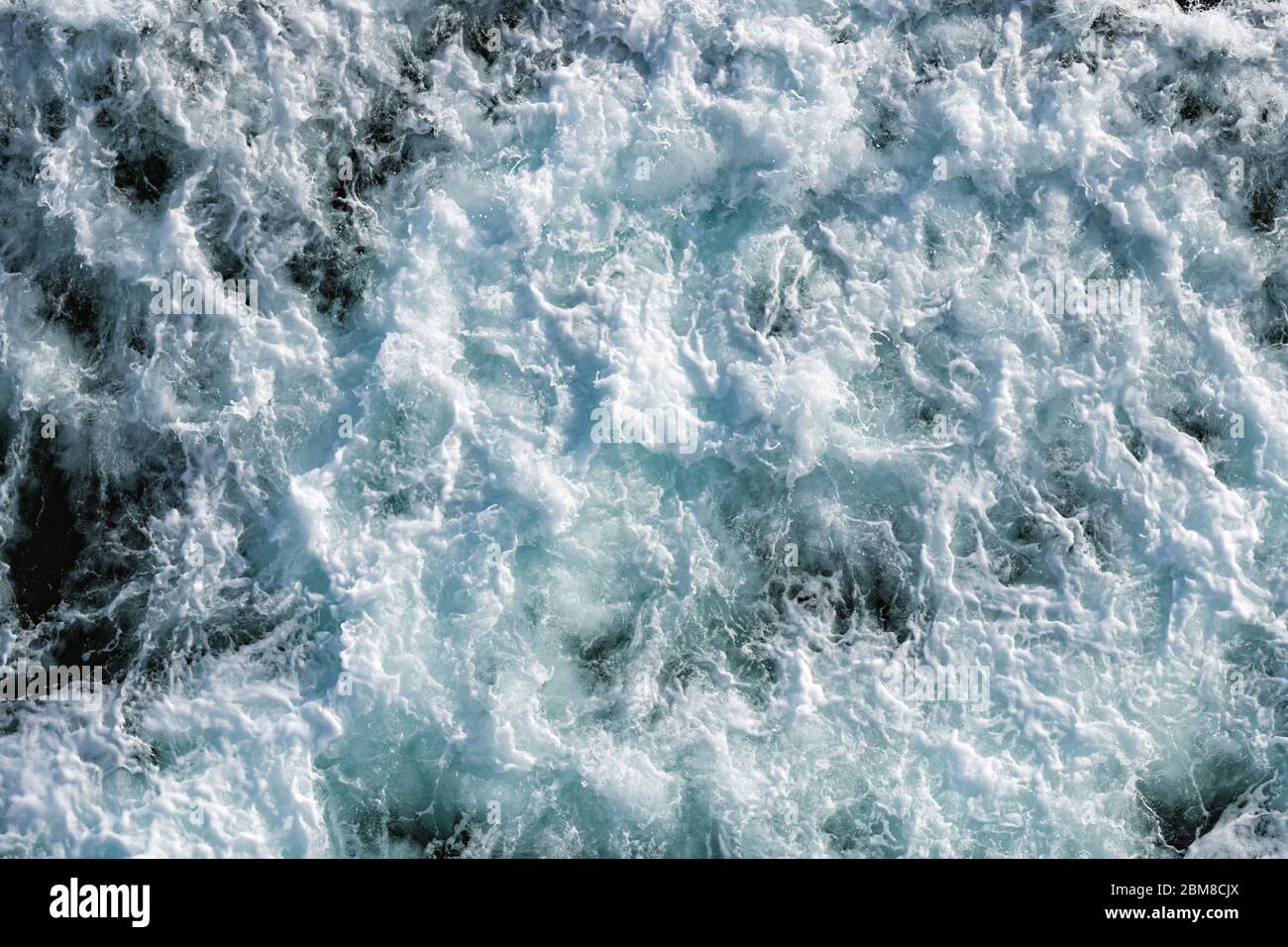 Ocean water abstract background. Sea bubbling water texture closeup Stock Photo