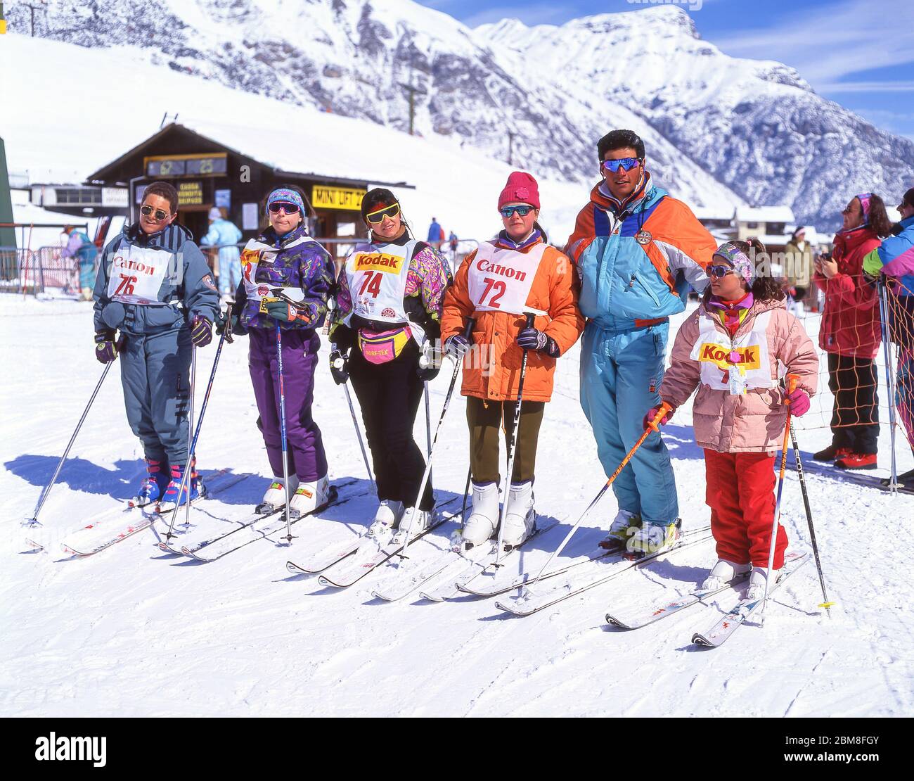 Ski instructor with class on lower slopes, Livigno, Alta Valtellina, Lombardy, Italy Stock Photo