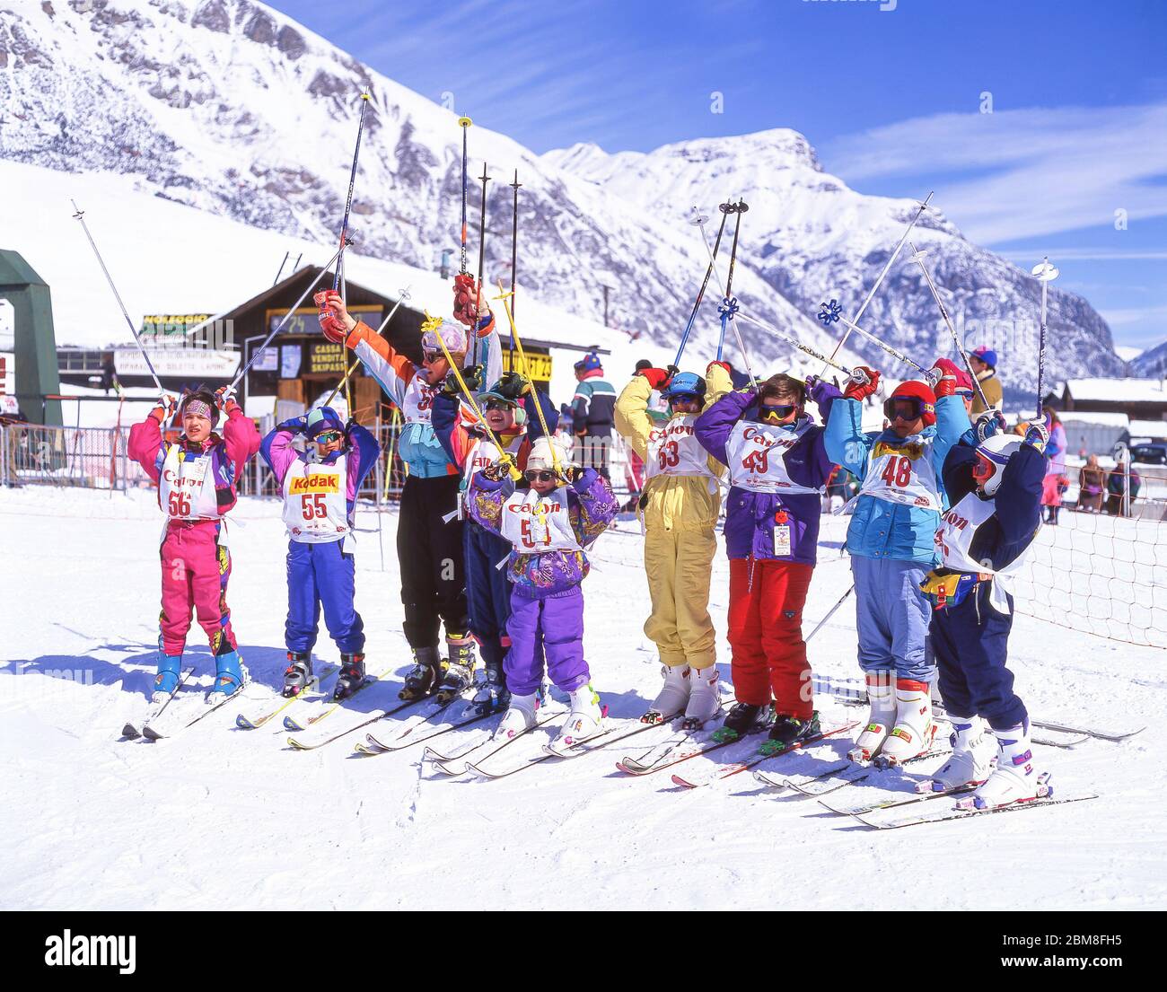 Ski instructor with children's class on lower slopes, Livigno, Alta Valtellina, Lombardy, Italy Stock Photo