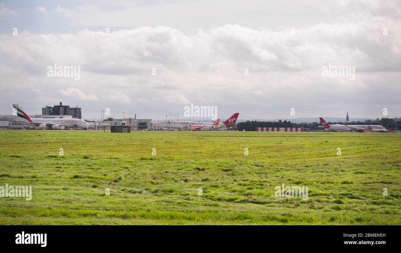 Glasgow, UK. 25 August 2019.  Pictured: 3 Jumbos jets at Glasgow which is a rare sight; (right) Virgin Atlantic Airbus A350-1000 aircraft seen at Glasgow International Airport for pilot training. Also seen (centre) is Virgin Atlantic Boeing 747-400 reg G-VROM; (left) Emirates Airlines Airbus A380-800. Credit: Colin Fisher/Alamy Live News. Stock Photo
