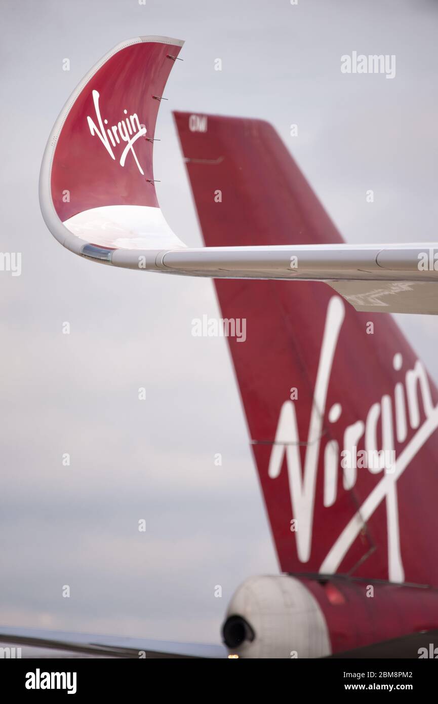 Glasgow, UK. 25 August 2019.  Pictured: (foreground) Virgin Atlantic's brand new flagship long haul aircraft, Airbus A350-1000 (reg G-VLUX) nicknamed Red Velvet which has the altar curved slender looking wingtips; (background), Virgin Atlantic Boeing 747-400 reg G-VROM nicknamed Barbarella is one of the long haul wide die body aircraft in Virgin's leisure fleet. Normally covering London Gatwick, this aircraft serves Glasgow 3 times per week. Credit: Colin Fisher/Alamy Live News. Stock Photo