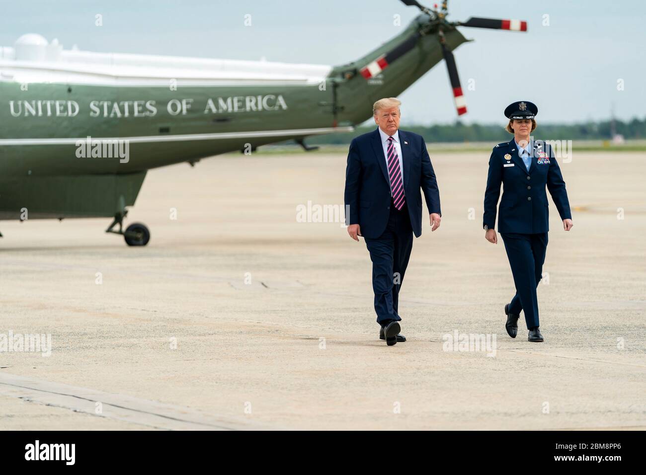 U.S. President Donald Trump, is escorted from Marine One to Air Force One by Air Force Col. Rebecca J. Sonkiss, Commander of the 89th Airlift Wing, at Joint Base Andrews May 5, 2020 in Clinton, Maryland. Trump is traveling to Phoenix, Arizona where he will deliver remarks at Honeywell International. Stock Photo