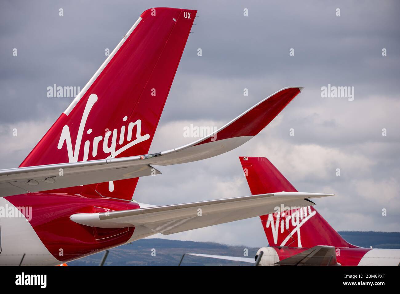 Glasgow, UK. 25 August 2019.  Pictured: (foreground) Virgin Atlantic's brand new flagship long haul aircraft, Airbus A350-1000 (reg G-VLUX) nicknamed Red Velvet which has the altar curved slender looking wingtips; (background), Virgin Atlantic Boeing 747-400 reg G-VROM nicknamed Barbarella is one of the long haul wide die body aircraft in Virgin's leisure fleet. Normally covering London Gatwick, this aircraft serves Glasgow 3 times per week. Credit: Colin Fisher/Alamy Live News. Stock Photo