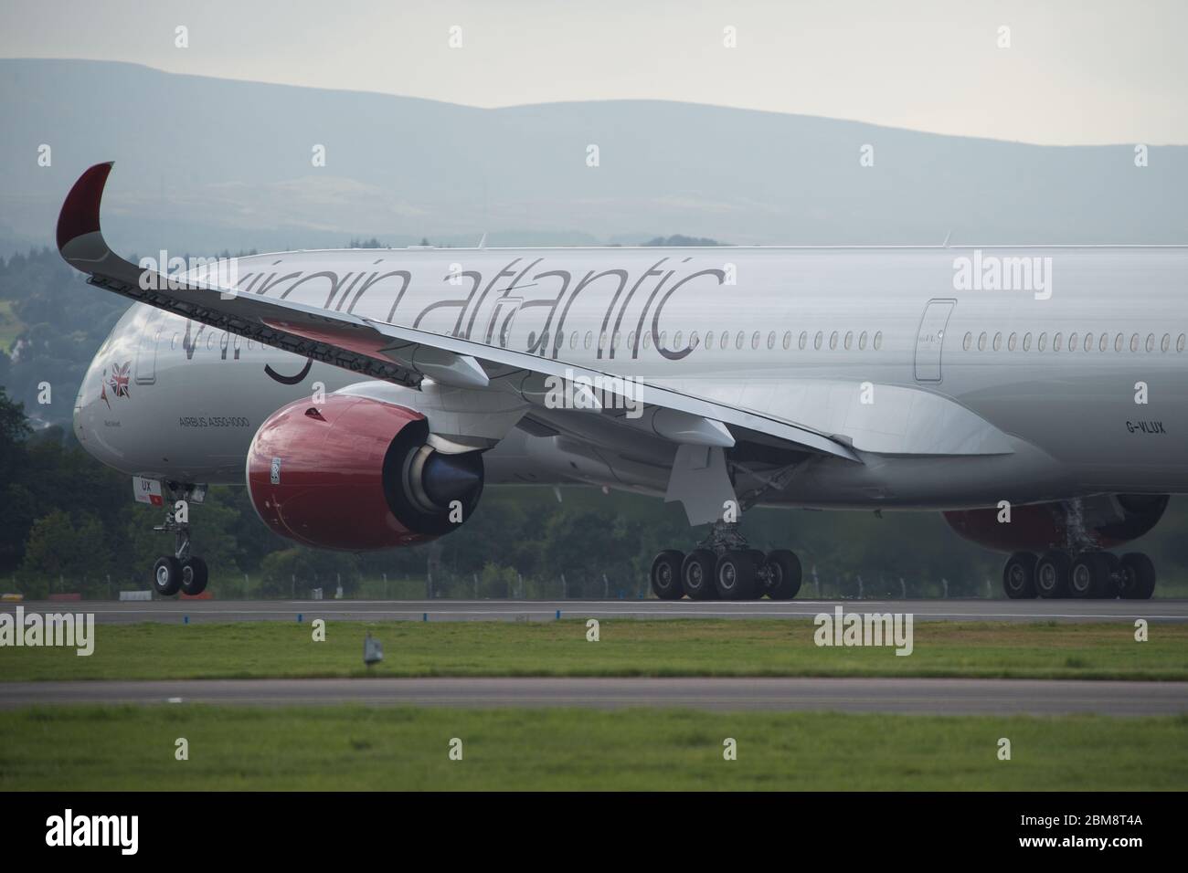 Glasgow, UK. 25 August 2019. Virgin Atlantic Airbus A350-1000 aircraft seen at Glasgow International Airport for pilot training. Virgin's brand new jumbo jet boasts an amazing new 'loft' social space with sofas in business class, and aptly adorned by the registration G-VLUX. The entire aircraft will also have access to high-speed Wi-Fi. Virgin Atlantic has ordered a total of 12 Airbus A350-1000s. They are all scheduled to join the fleet by 2021 in an order worth an estimated $4.4 billion (£3.36 billion). Credit: Colin Fisher/Alamy Live News. Stock Photo