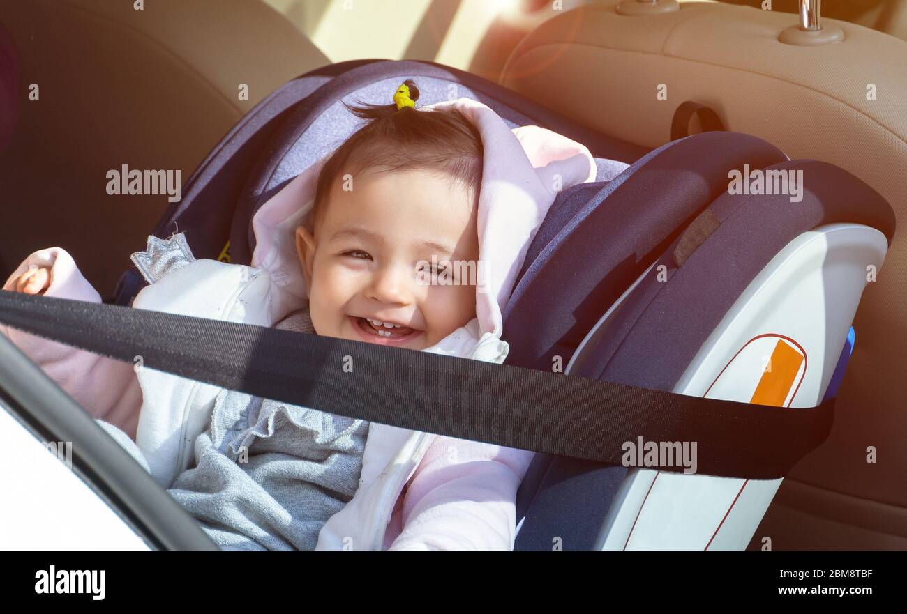smiling baby in baby car seat in the vehicle Stock Photo