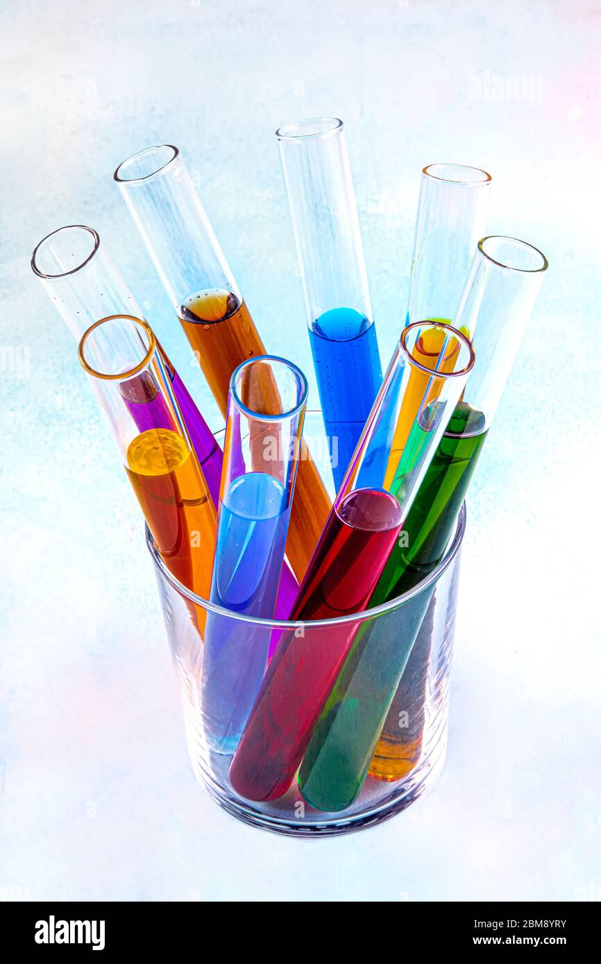 Test tubes in a rack containing rainbow colored solutions. Laboratory