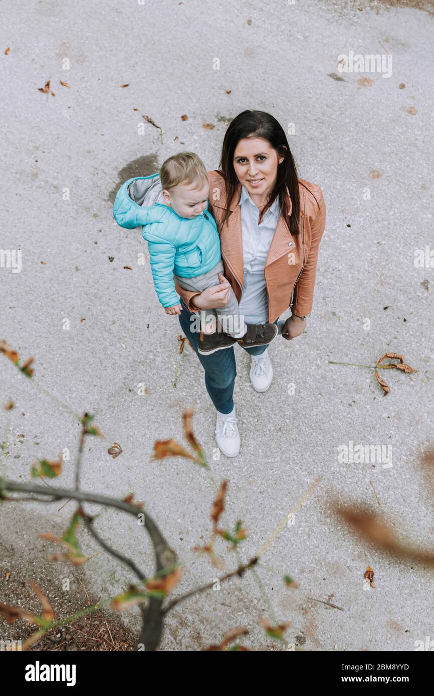 Young beautiful woman and her 1 year old son outdoors, family love Stock Photo