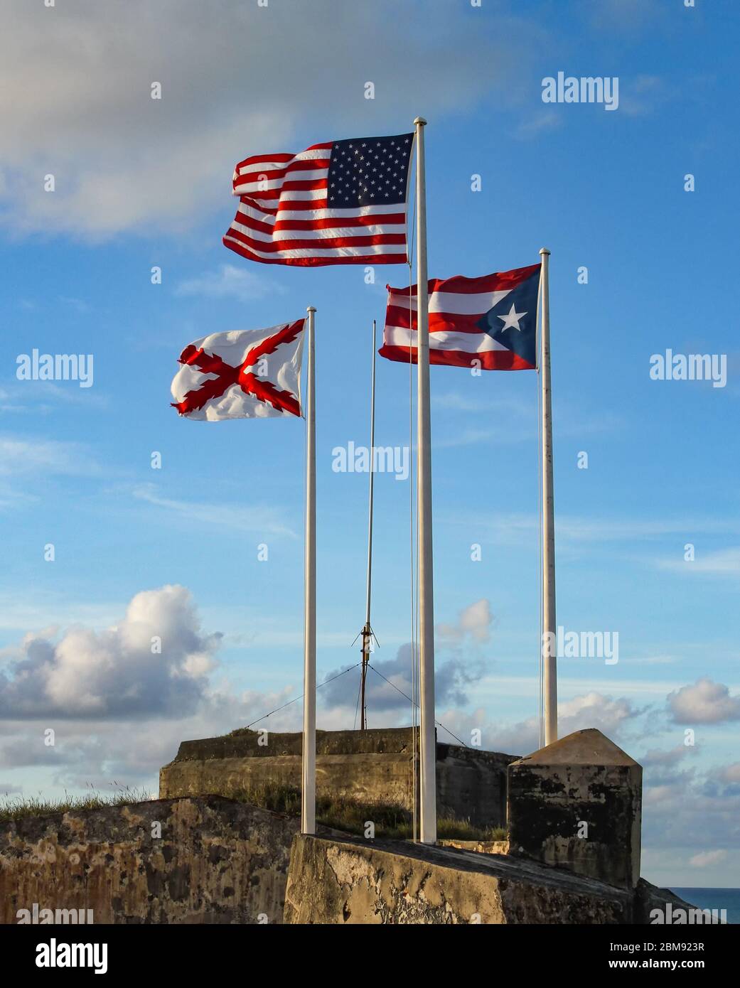 The three flags that fly at El Morro in Old San Juan, Puerto Rico. American, Puerto Rican and Cross of Burgundy flags. Stock Photo