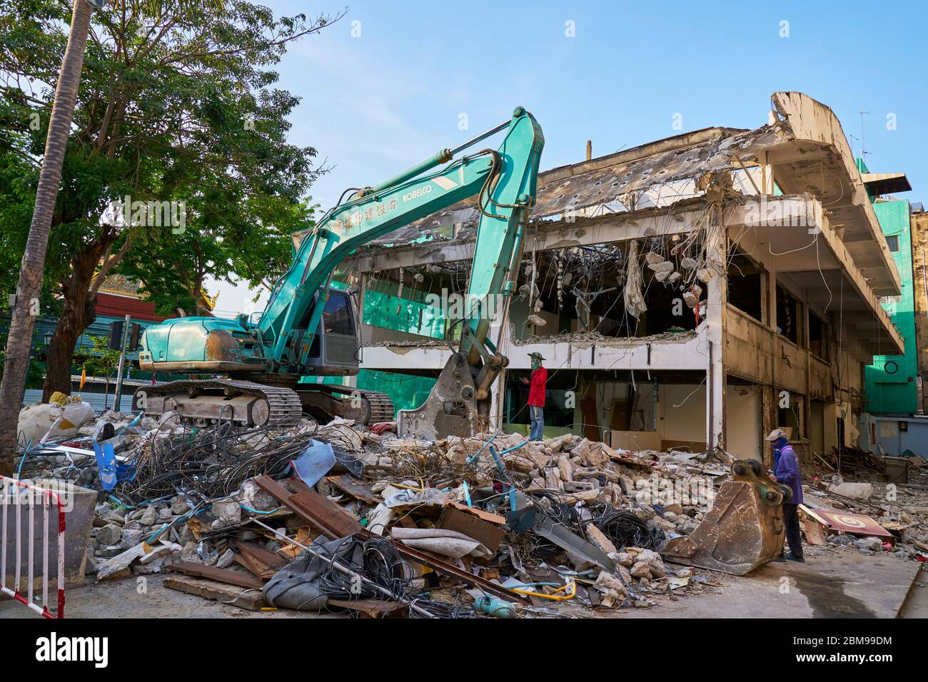 excavartor demolishing a block on the khao san road, Bangkok Stock Photo