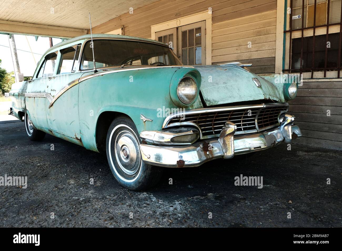 Two tone green unrestored 1956 Ford Fairlane Town Sedan car or automobile parked in a carport in Alabama, USA. Stock Photo