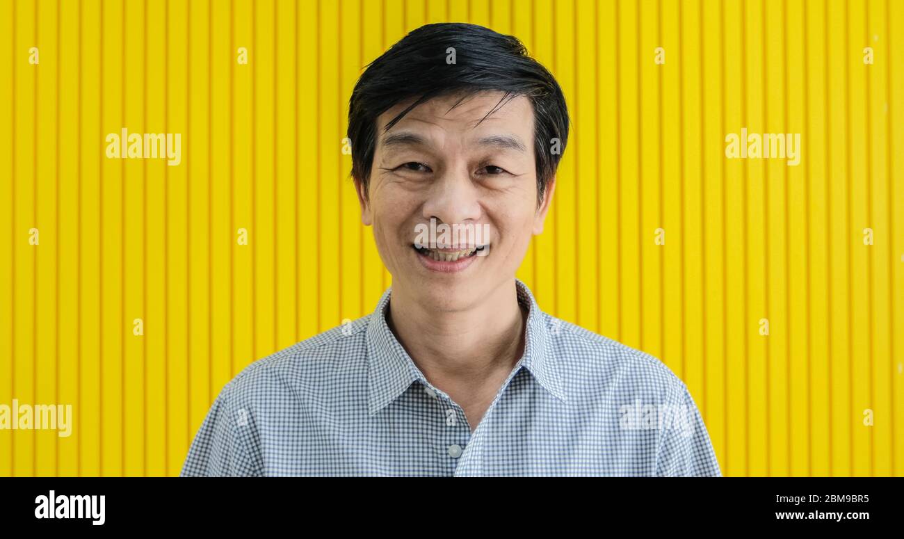 A senior Asian man smiled and laughed happily at home. Stock Photo