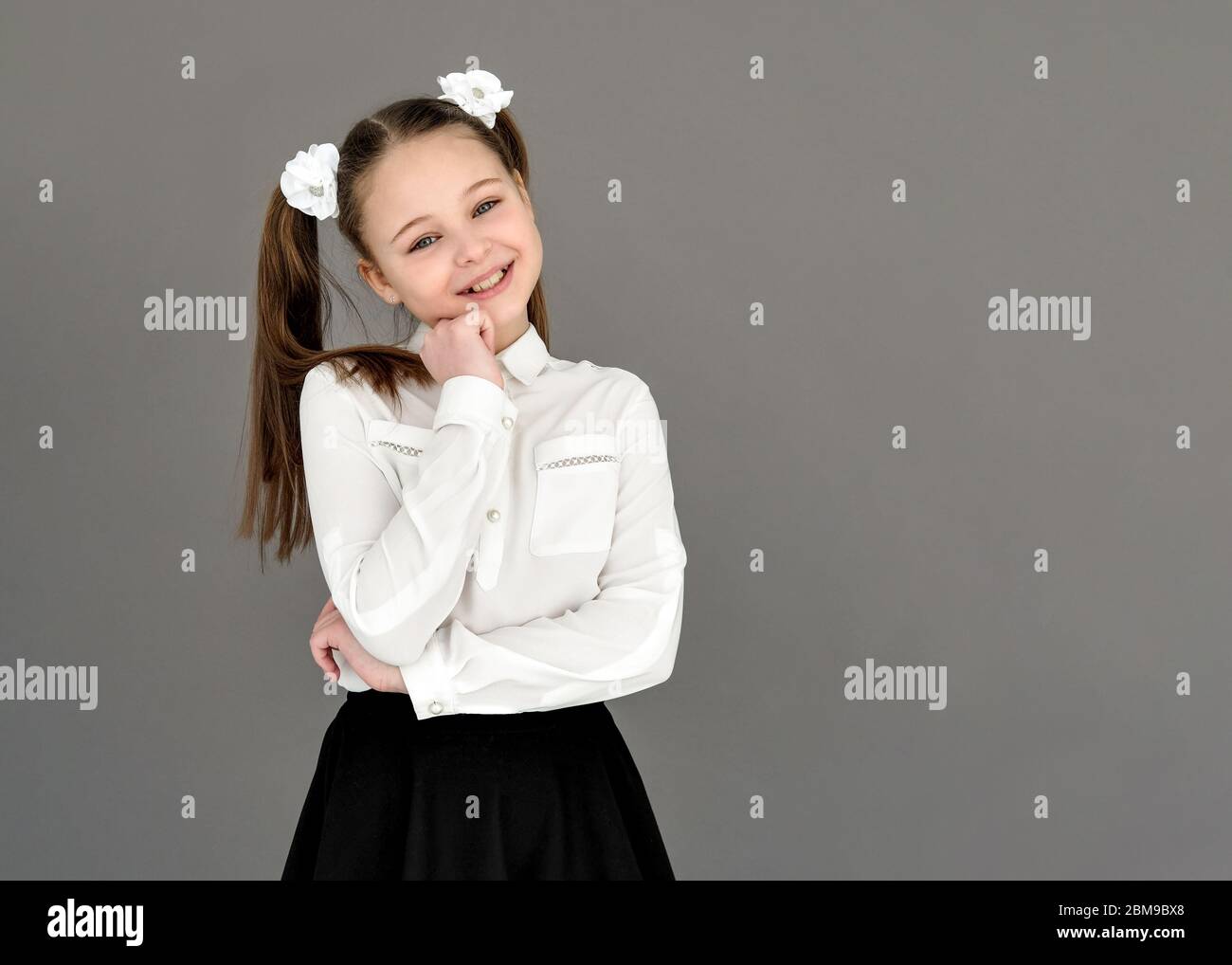 beautiful girl in a school uniform. Expression of happiness and joy. On