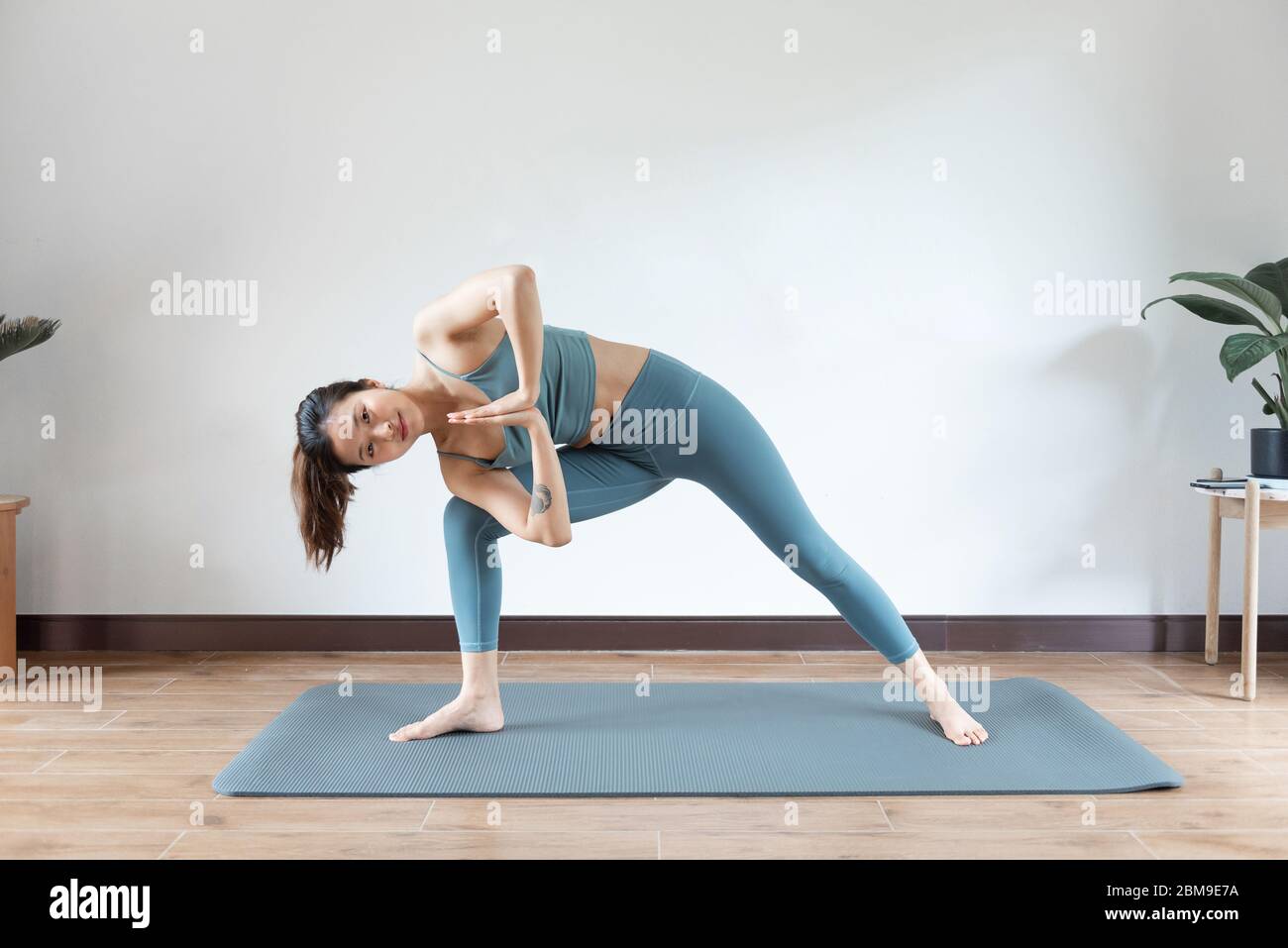 Yoga, Asian woman doing exercise isolated over white Stock Photo - Alamy
