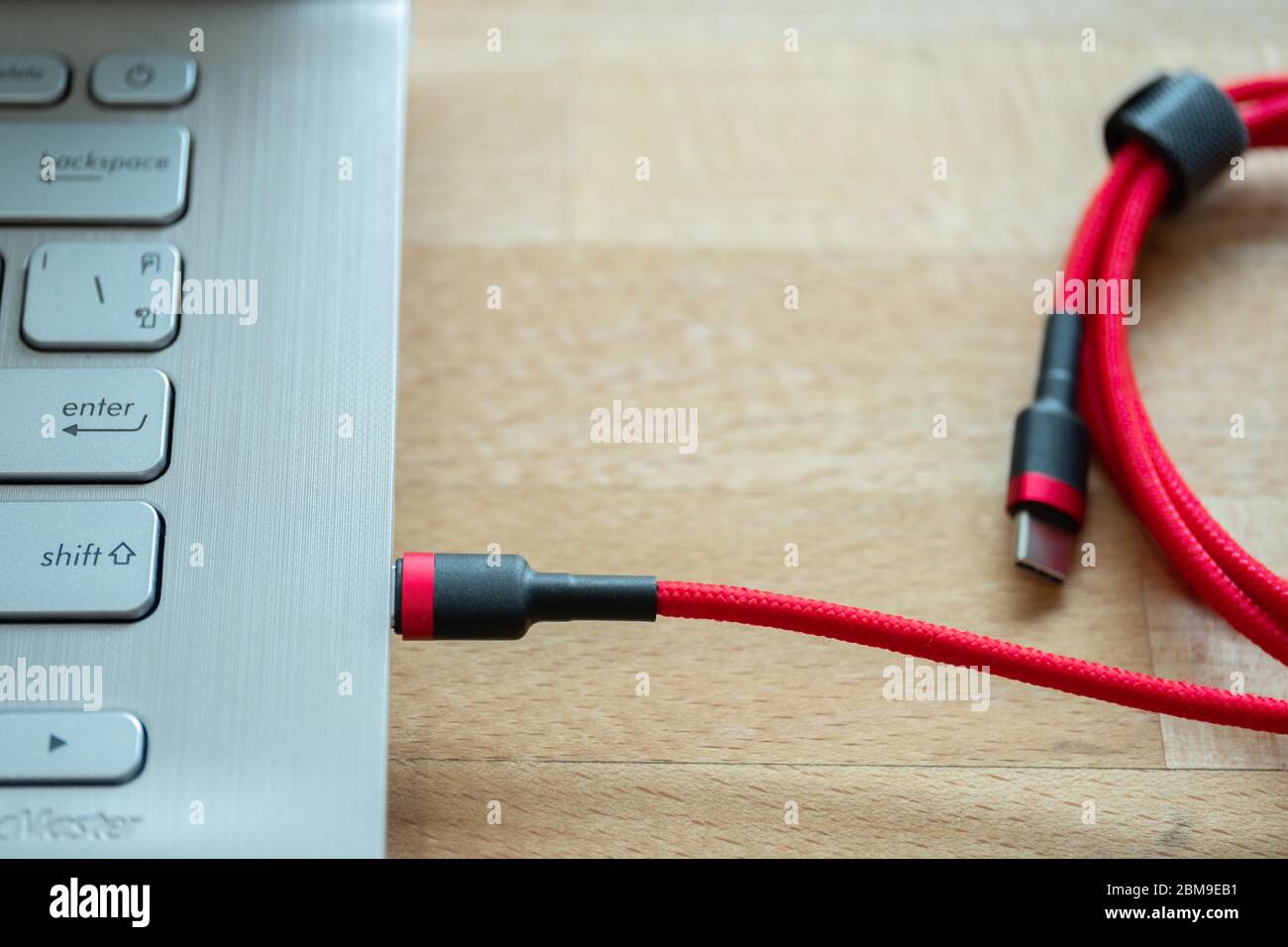 The USB type c is a hi speed data transfer and quick or fast charge battery.It a new connector port of a computer , laptop, or cell phone.A red cable Stock Photo