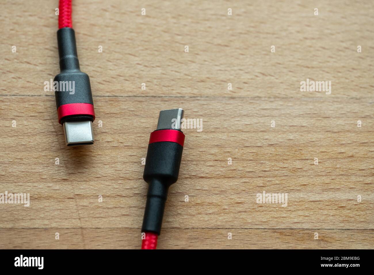 The USB type c is a hi speed data transfer and quick or fast charge battery.It a new connector port of a computer , laptop, or cell phone.A red cable Stock Photo