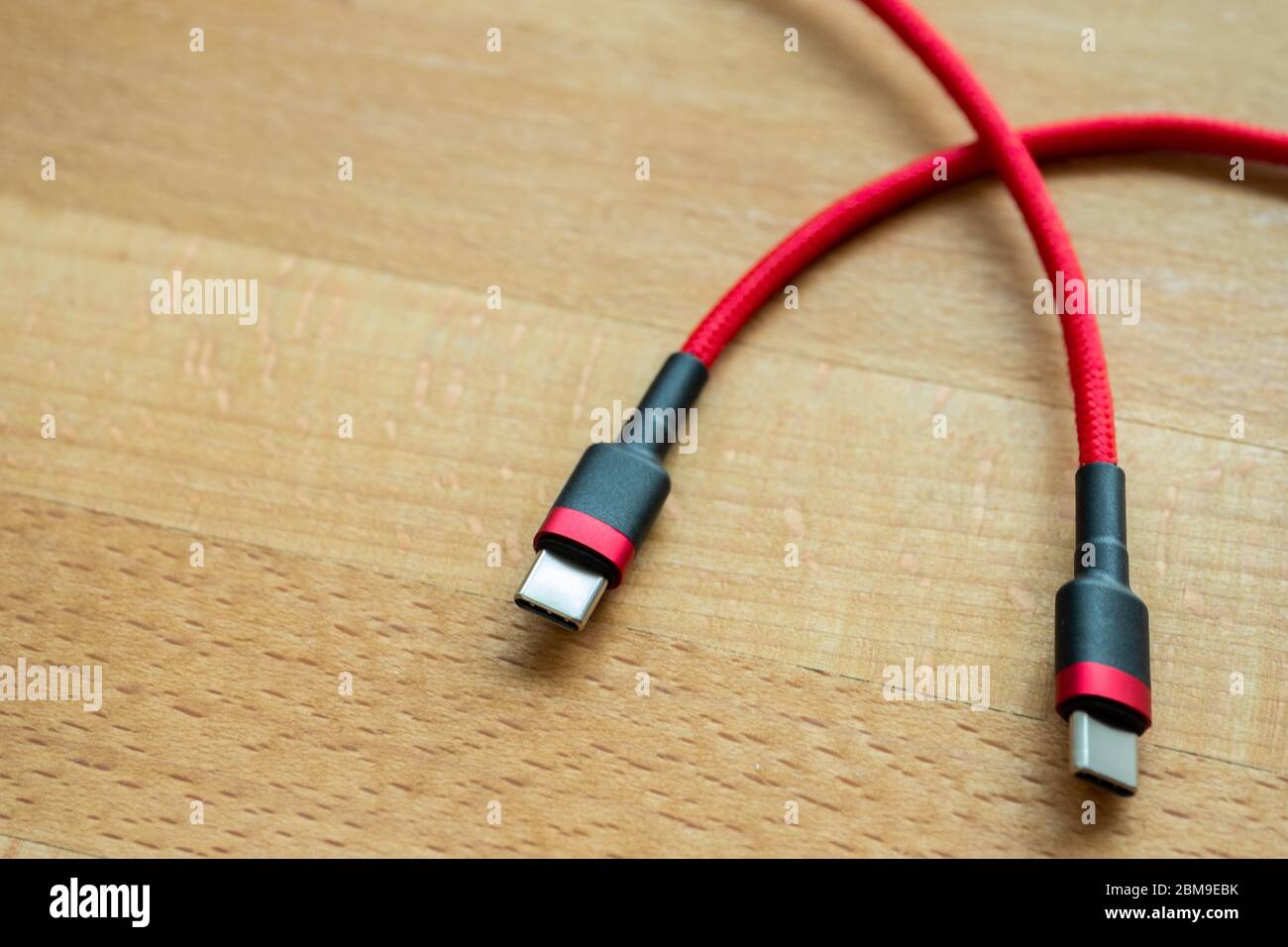 The USB type c is a hi speed data transfer and quick or fast charge battery.It a new connector port of a computer , laptop, or cell phone.A red cable Stock Photo