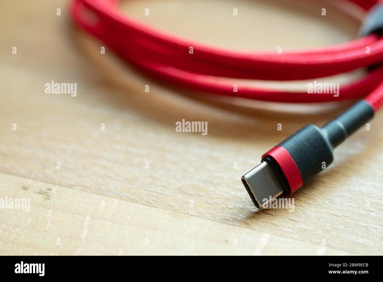 The USB type c is a hi speed data transfer and quick or fast charge battery.It a new connector port of a computer , laptop, or cell phone.A red cable Stock Photo