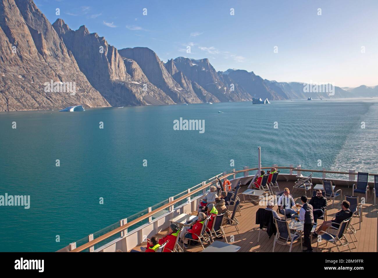 Passengers on deck on a cruise ship in Øfiord in eastern Greenland Stock Photo