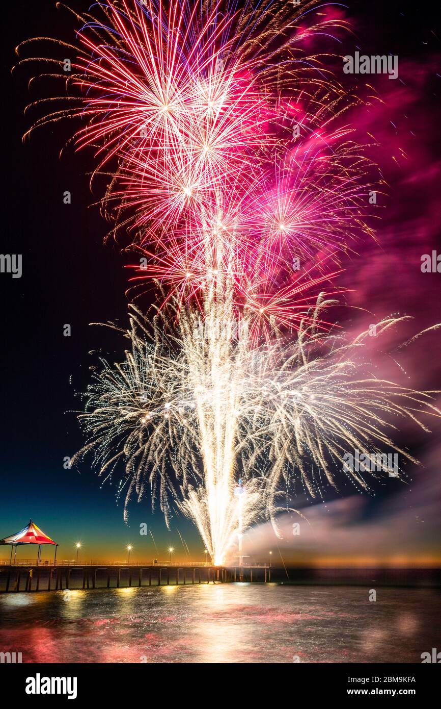 Colourful New Years Fireworks Display lighting up the sky and water off Brighton Jetty, Adelaide, South Australia Stock Photo