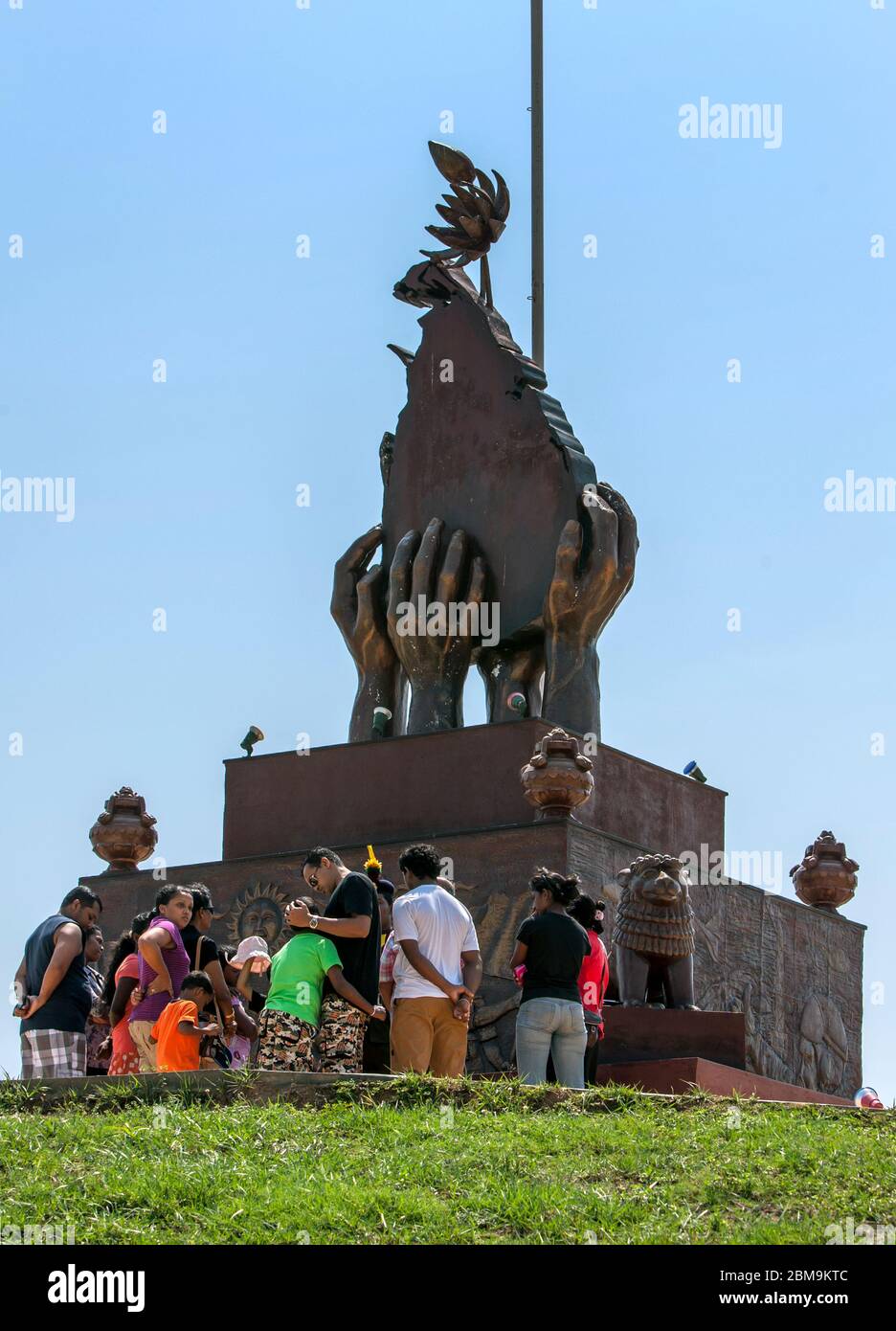 People stand below The Elephant Pass War Memorial in Sri Lanka built to commemorate the heroic troops of the Sri Lankan Military. Stock Photo