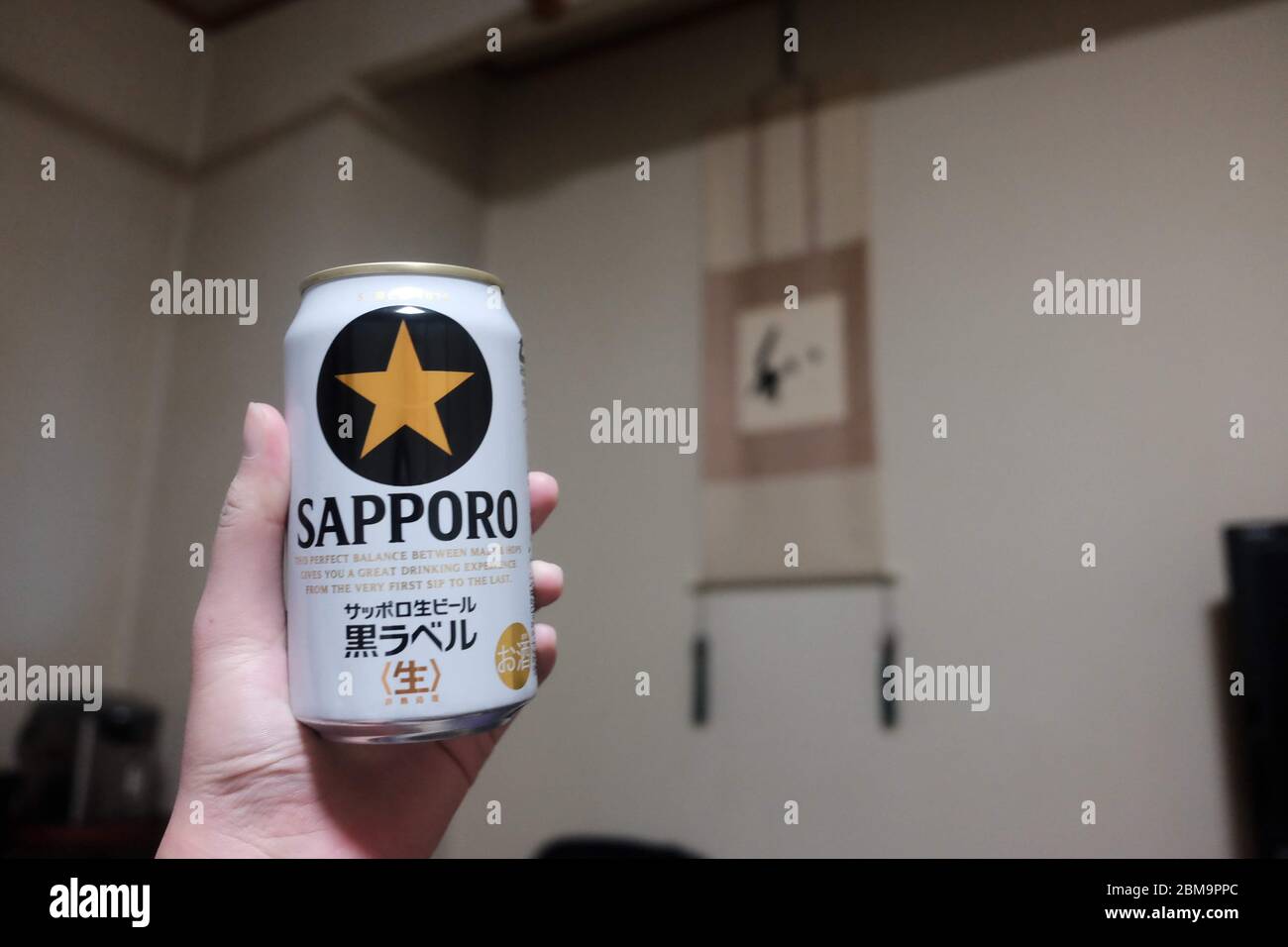 Sapporo Beer in Hand in Room in Japan Stock Photo