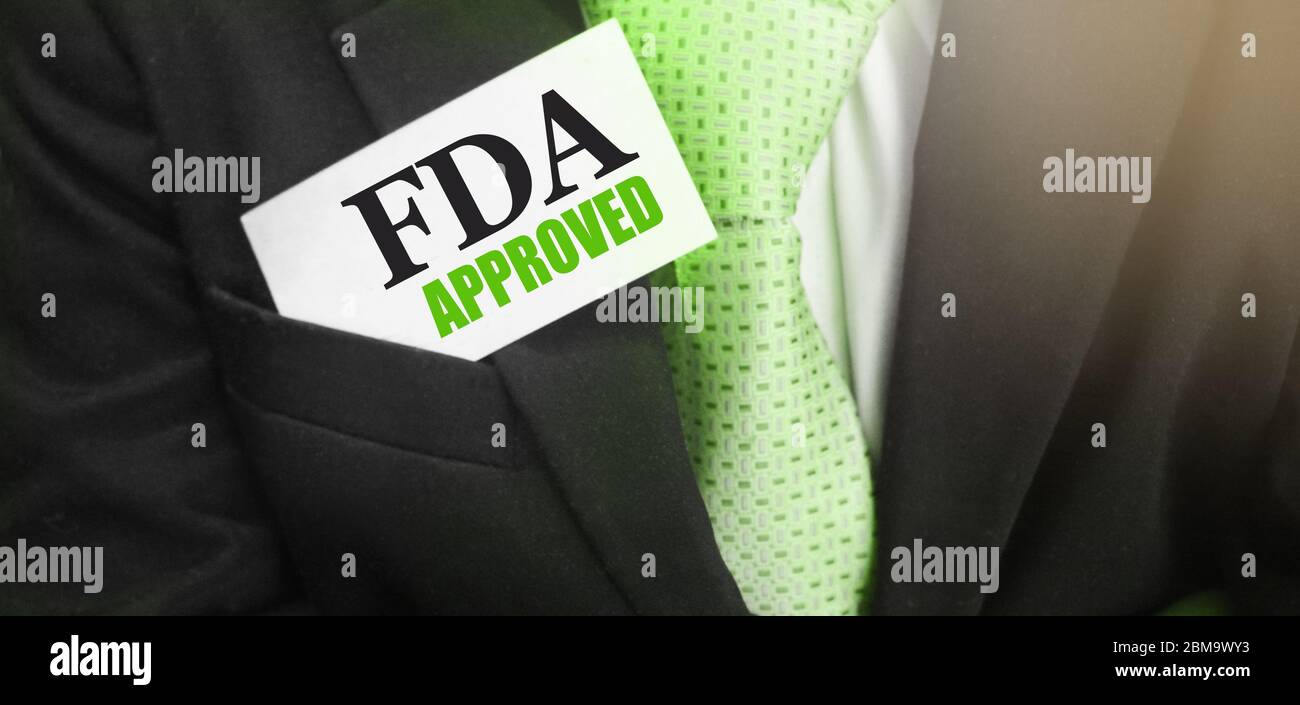 FDA Approved words on card in upper pochet of businessman suit. Food and  Drugs Association approved products concept Stock Photo - Alamy